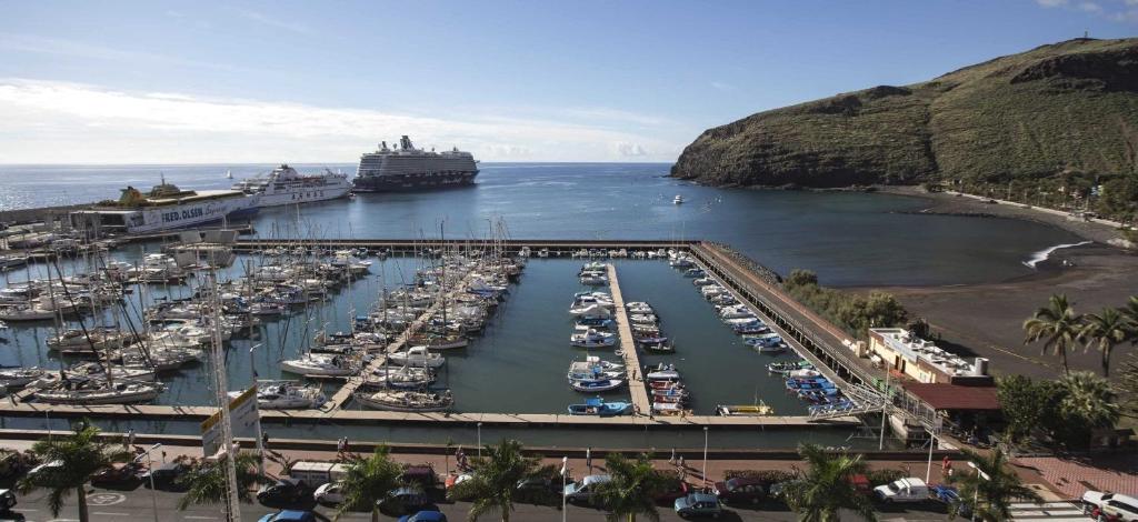 a group of boats docked in a harbor with a cruise ship at Casa Vera in San Sebastián de la Gomera