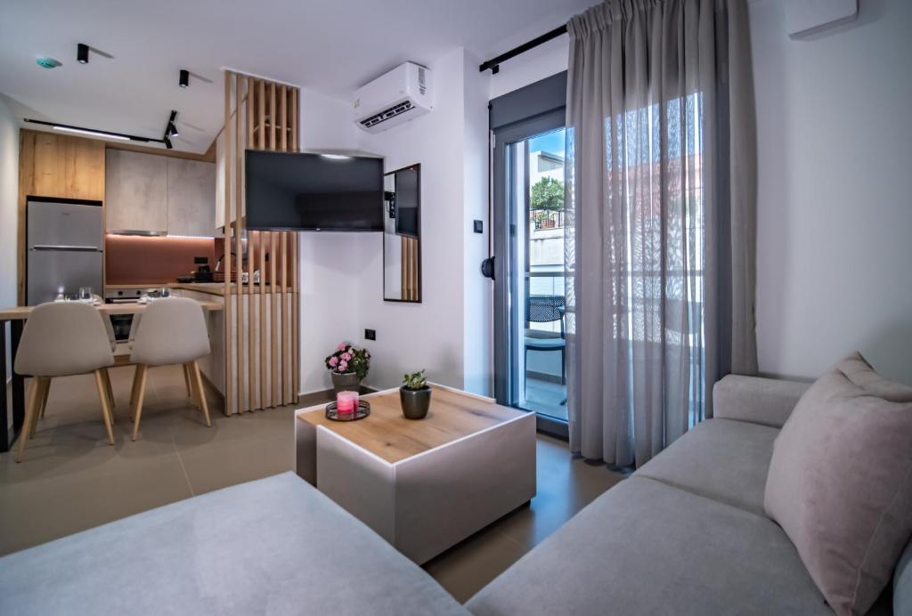 a living room with a couch and a table at Nestia urban apartments in Volos