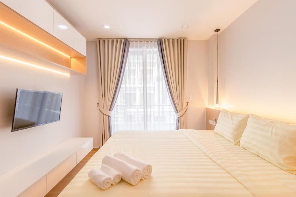 Postel nebo postele na pokoji v ubytování Sky Park Condotel & Residence