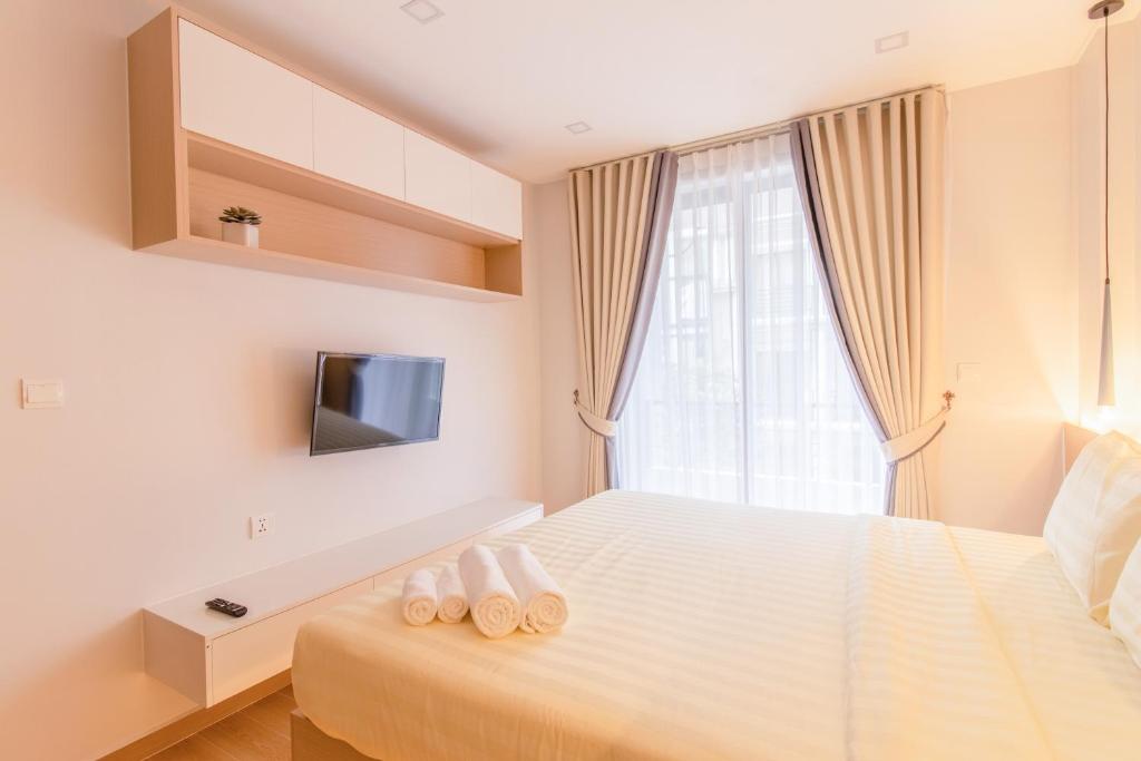 Postel nebo postele na pokoji v ubytování Sky Park Condotel & Residence