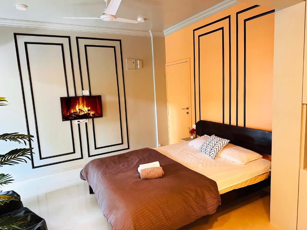 a bedroom with a bed with a lamp and a window at The Studio: AC, WiFi, Smart Tv in Pune