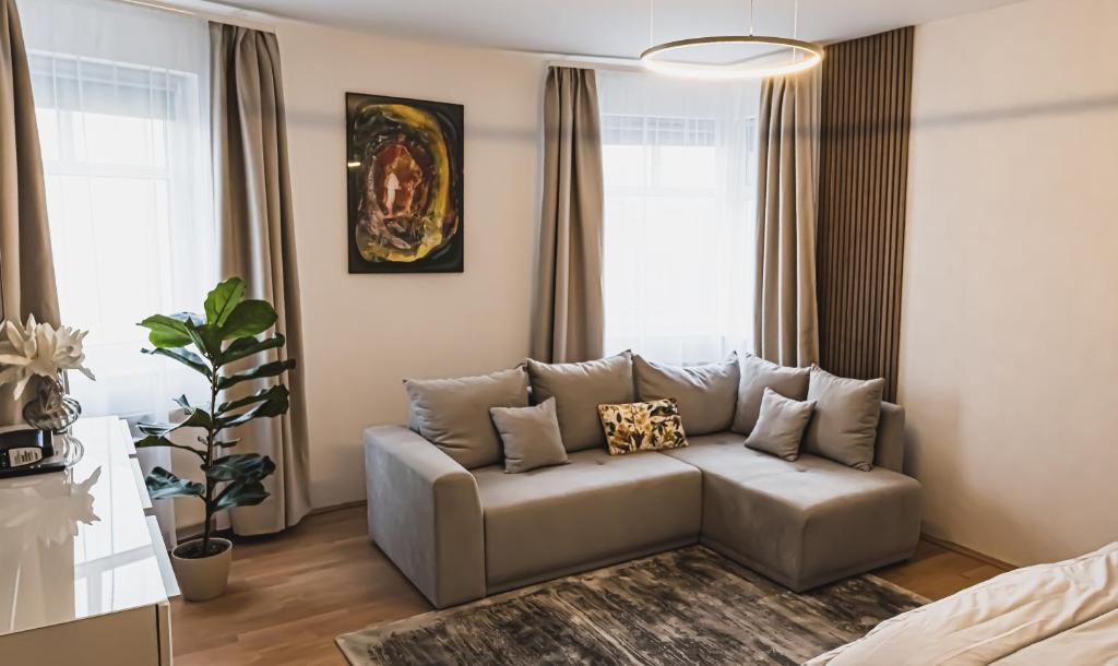 a living room with a couch in a room at Rosegarden Apartman in Sárospatak