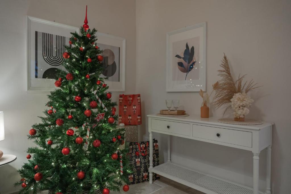 a christmas tree in a living room with a fireplace at Palazzo Marzionna in Polignano a Mare