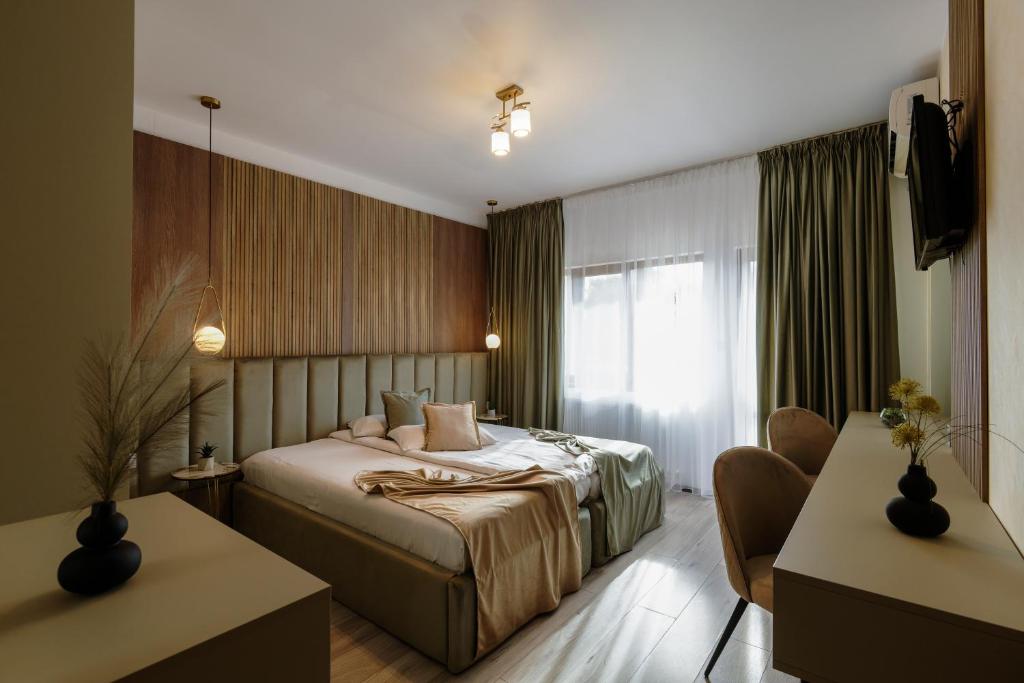 a hotel room with a bed and a window at Residence Riverside in Galaţi