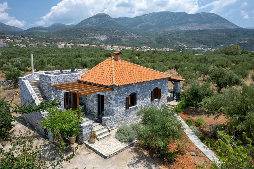 a small stone house with an orange roof at Spiti-ELEONAS in Agios Nikolaos