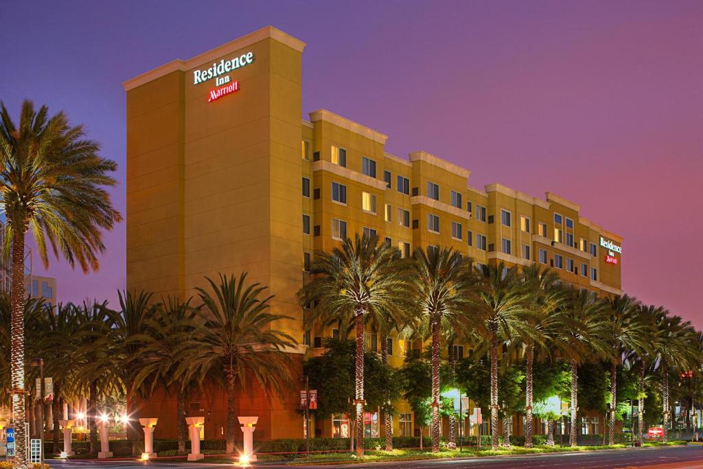 a hotel with palm trees in front of a building at Residence Inn by Marriott Anaheim Resort Area/Garden Grove in Anaheim