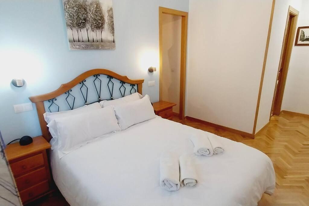 a bedroom with a white bed with white pillows at Manzanares Getaway in Manzanares el Real