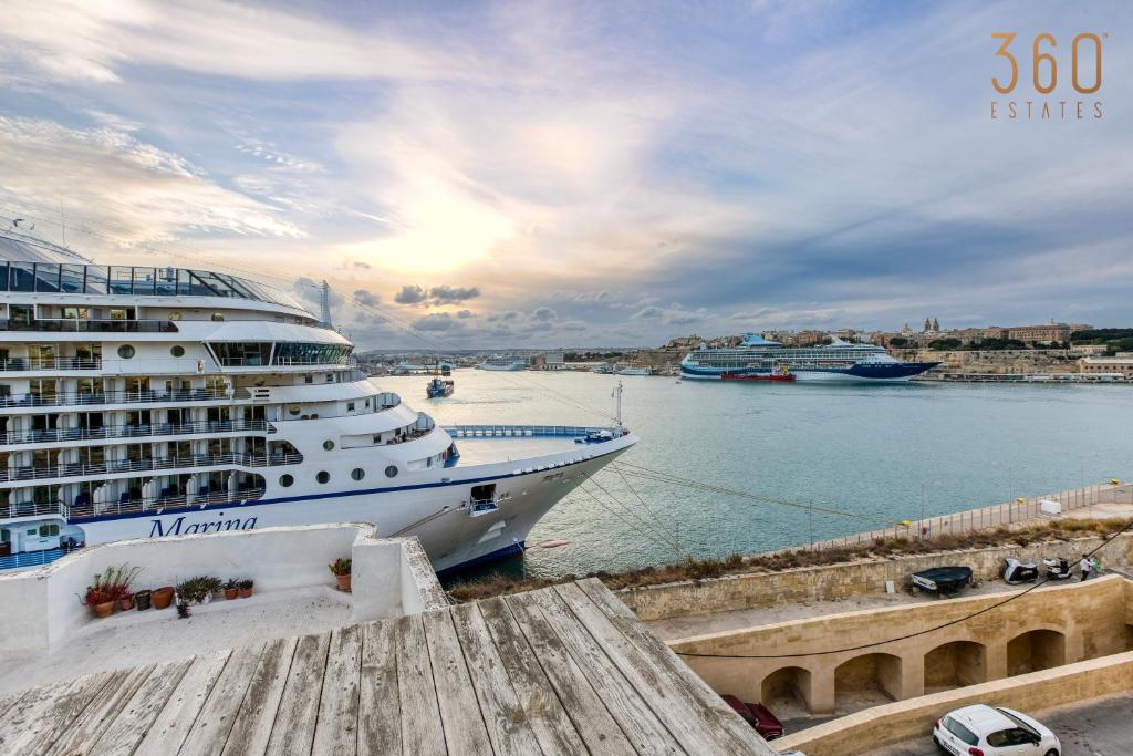 a large cruise ship docked in a harbor at A lovely, 1BR home with lovely views in Isla BY 360 Estates in Senglea