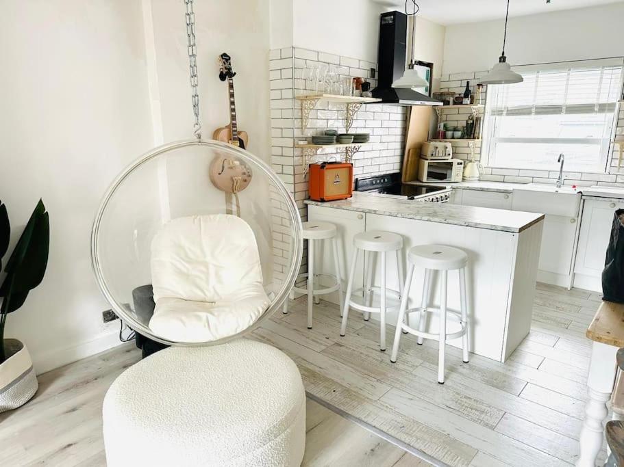 a kitchen with a round table and stools in it at Stunning 2 bedroom flat Camden in London