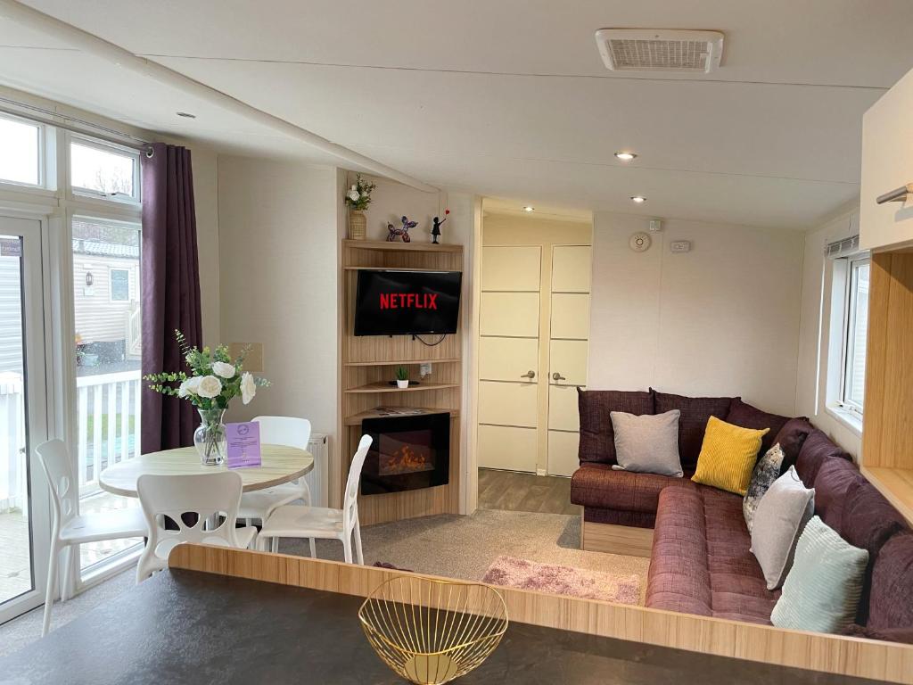 a living room with a couch and a table at 3 bedroom luxury caravan haven, marton mere in Blackpool