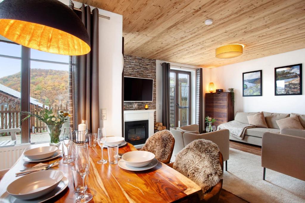 a living room with a wooden table and a couch at Bergchalet 20 in Diemelsee