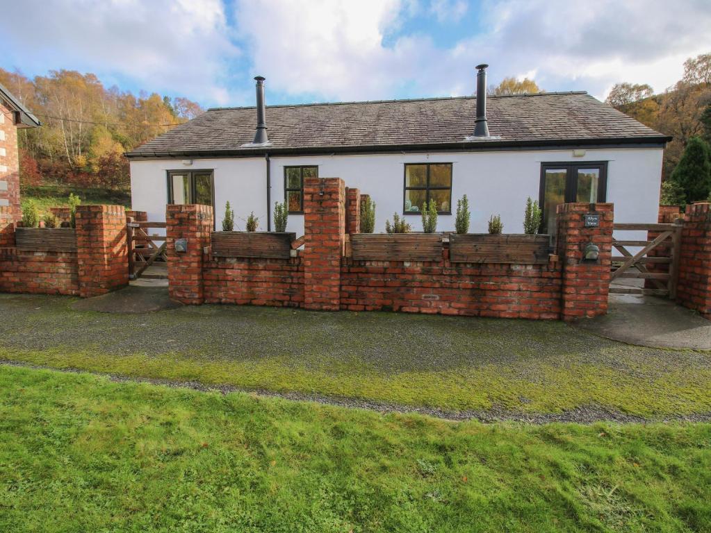 a brick fence in front of a house at Meadow View in Mold