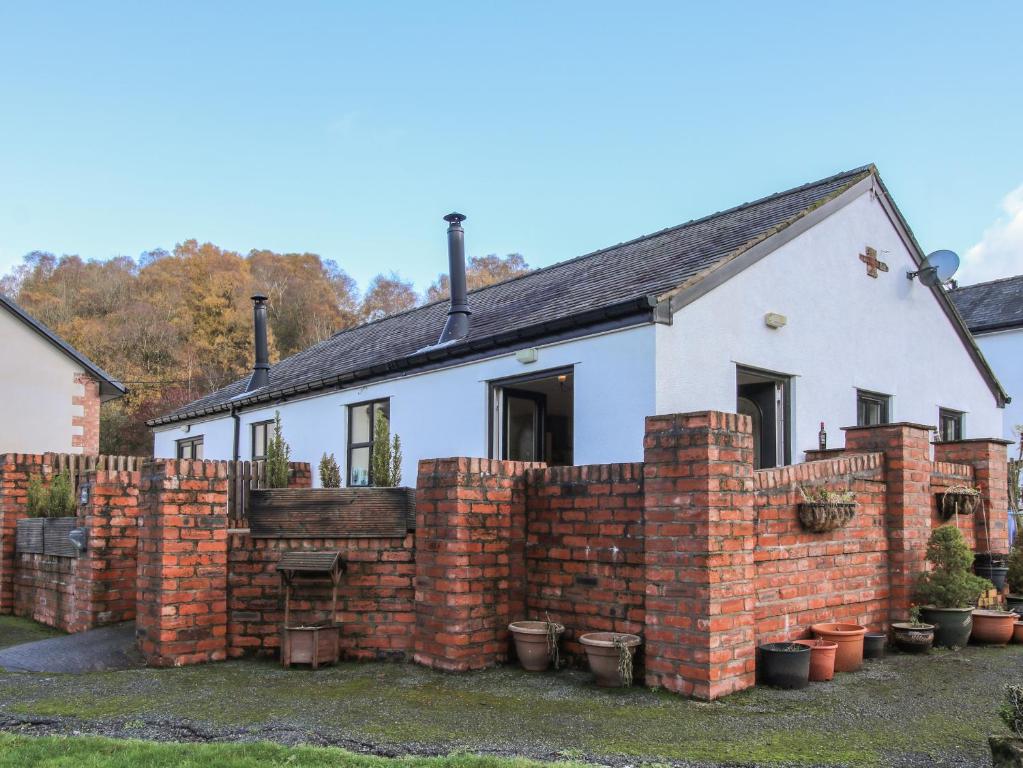 a brick fence in front of a house at Alyn View in Llanferres