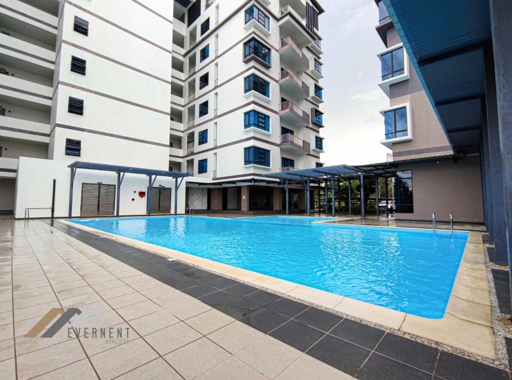 an empty swimming pool in front of a building at Sun Sky by Evernent in Miri