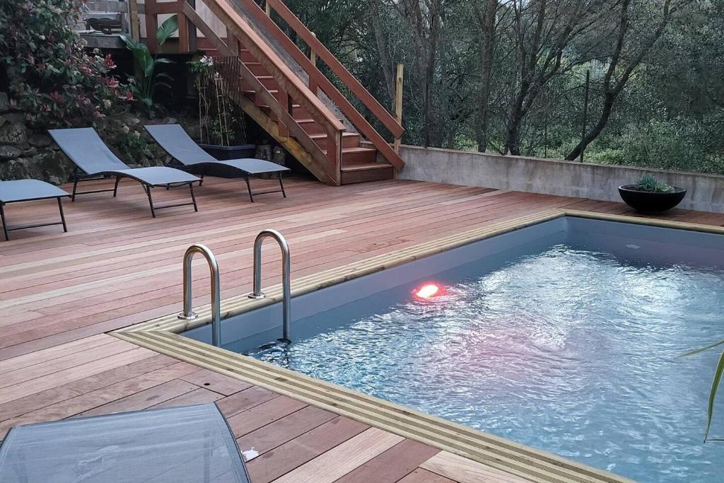 een zwembad op een houten dek met een trap bij Casa Marcelli 4 in Porto-Vecchio