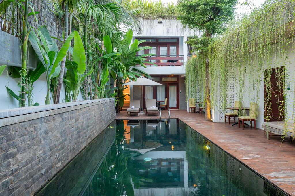 a swimming pool in the middle of a house at Victoria Central Residence in Siem Reap