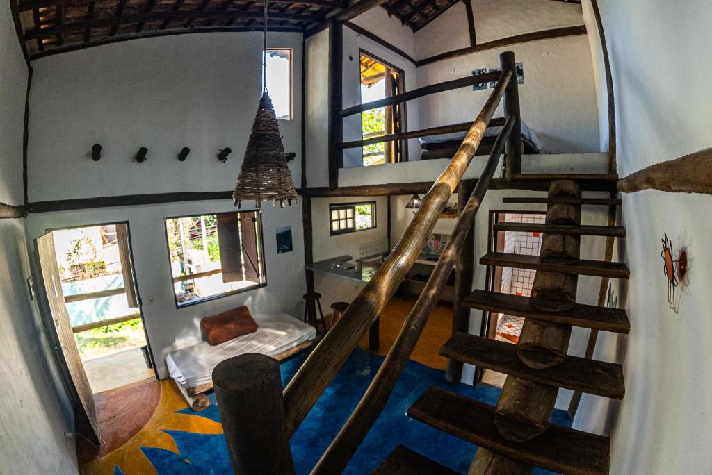 an overhead view of a room with a spiral staircase at Duplex Sol in Maresias