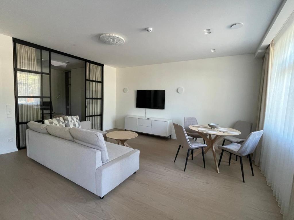 a living room with a couch and a table at Balance in Nida in Nida