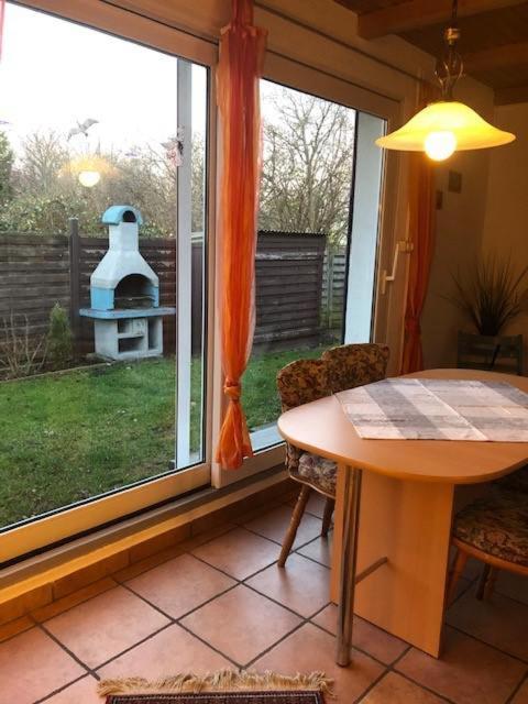 a dining room with a table and a window at Memelstrasse 6 in Dahme