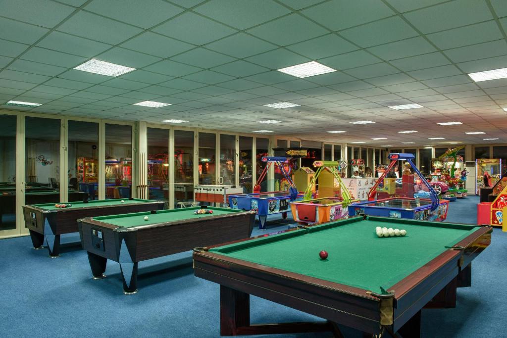 a room with two pool tables and arcade games at Megasaray Club Belek in Belek