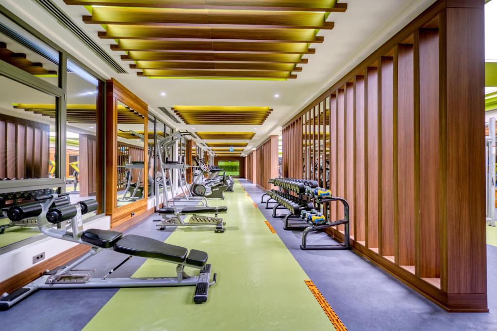 a gym with a row of treadmills and machines at Megasaray Club Belek in Belek