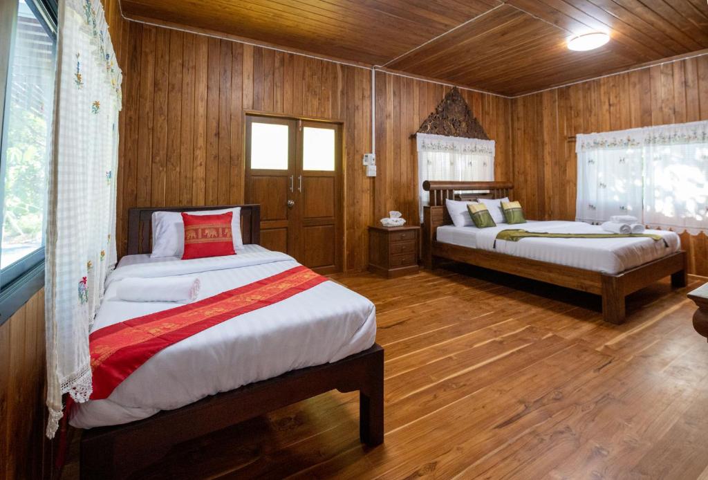 Postel nebo postele na pokoji v ubytování Suk Sabai Homestay