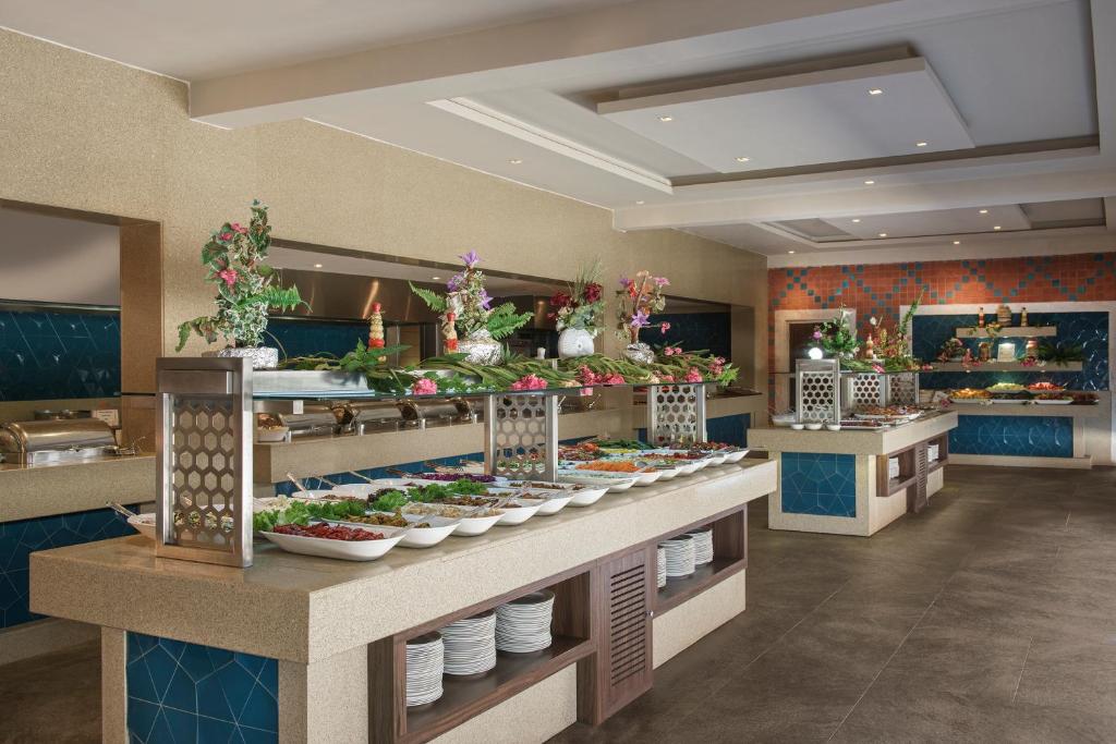 a buffet line with plates of food in a restaurant at Megasaray Club Belek in Belek