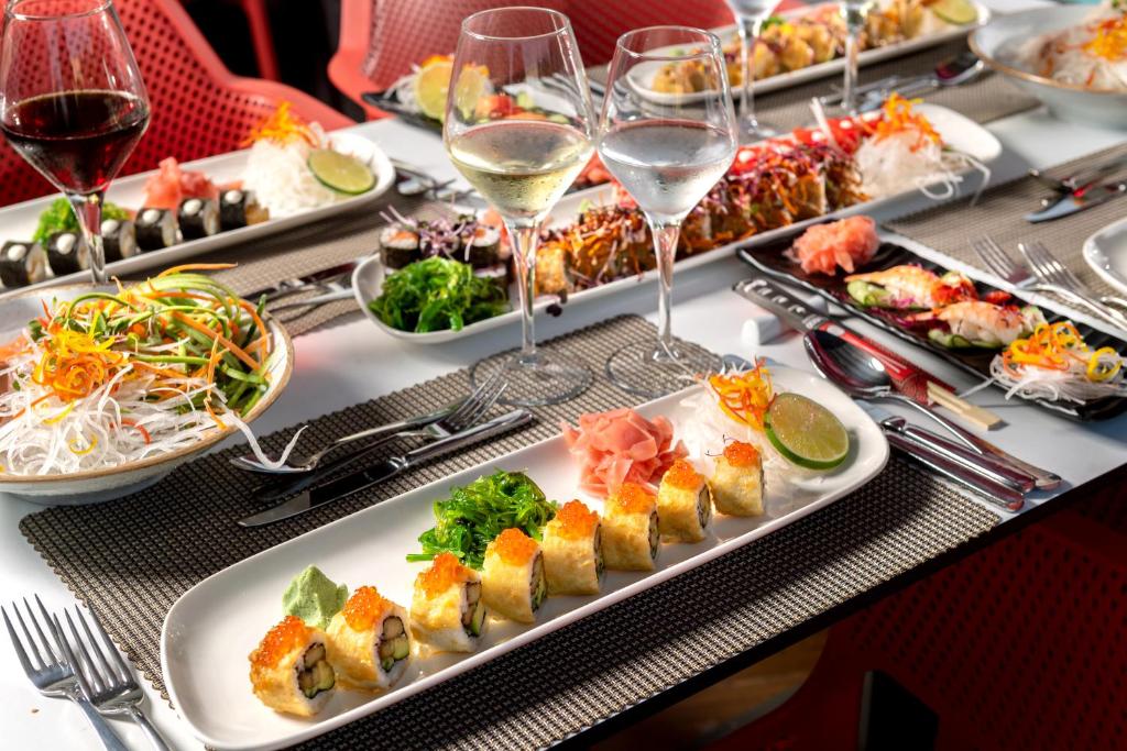 a table with plates of food and glasses of wine at Megasaray Club Belek in Belek
