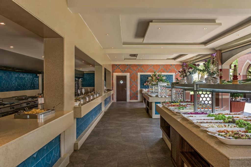 a buffet line with many plates of food at Megasaray Club Belek in Belek