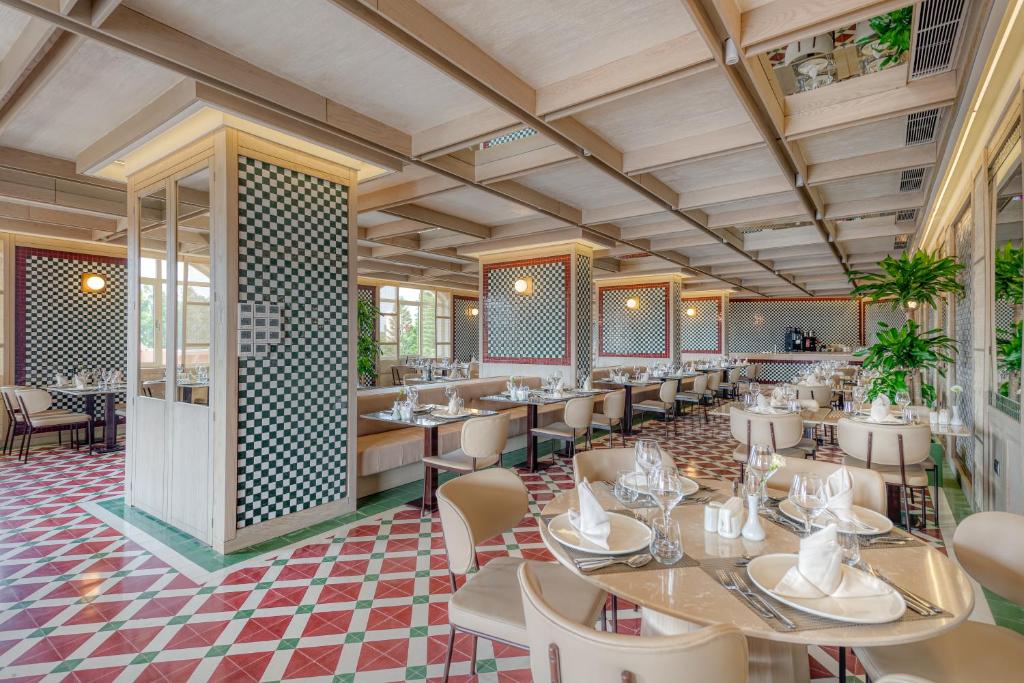 a restaurant with tables and chairs in a room at Megasaray Club Belek in Belek