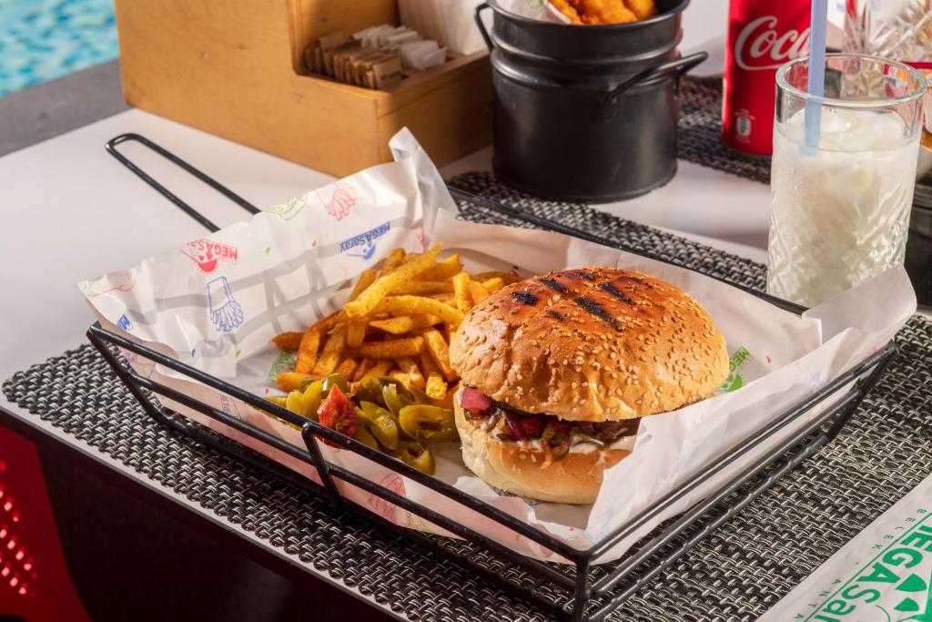 a tray with a sandwich and french fries on a table at Megasaray Club Belek in Belek
