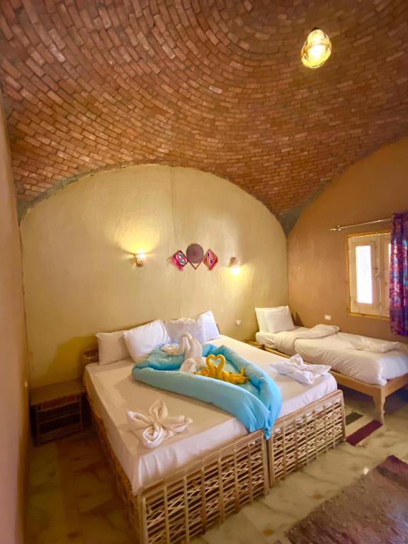 Postel nebo postele na pokoji v ubytování Kabara Nubian House