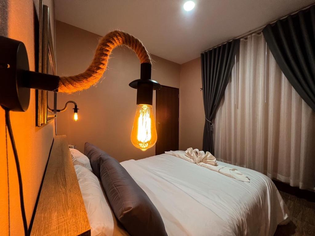 a hotel room with a bed with a snake on the wall at PP Pool Villa Maesalong Chiangrai in Mae Salong Nai