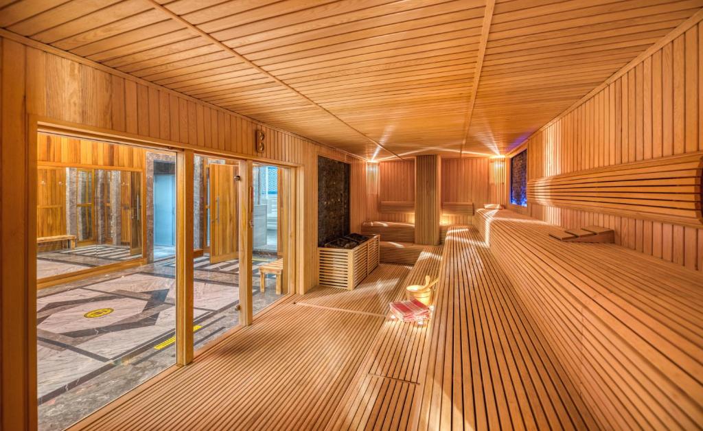 a large room with wooden flooring and a large window at Megasaray Club Belek in Belek