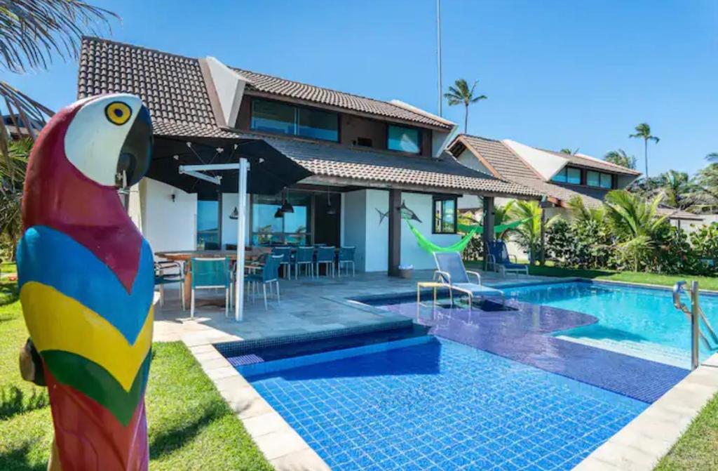a villa with a pool and a house at Bangalô luxo à beira MAR em Porto de Galinhas (Cupe) in Recife