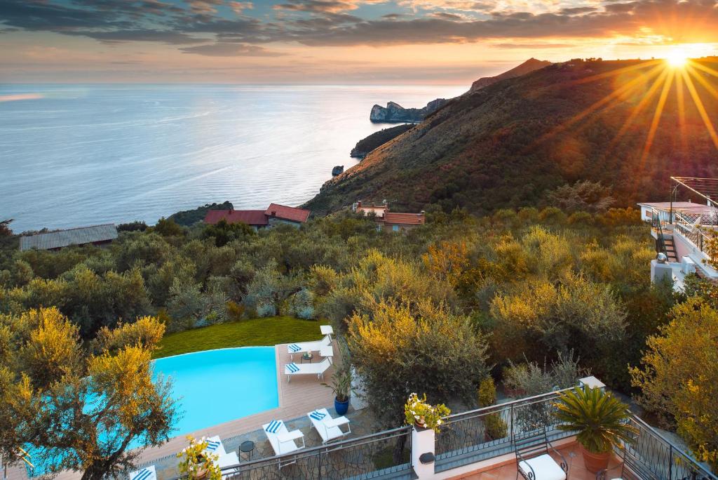a villa with a pool and a view of the ocean at Villa Chez Piè with Heated Infinity Pool in SantʼAgata sui Due Golfi