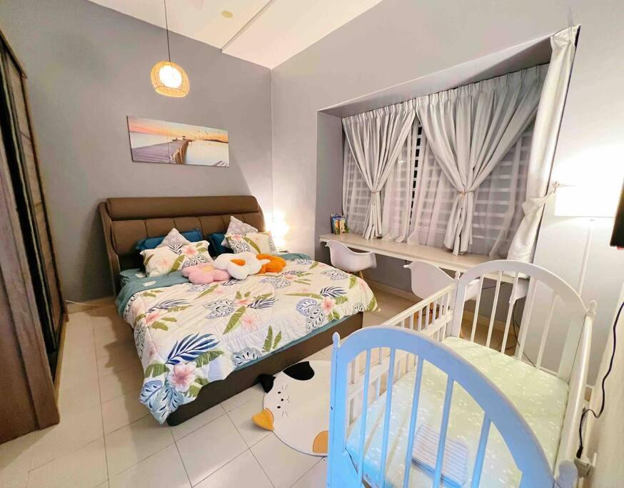 a childs bedroom with a bed and a crib at THE BLUE HOUSE in Kamunting