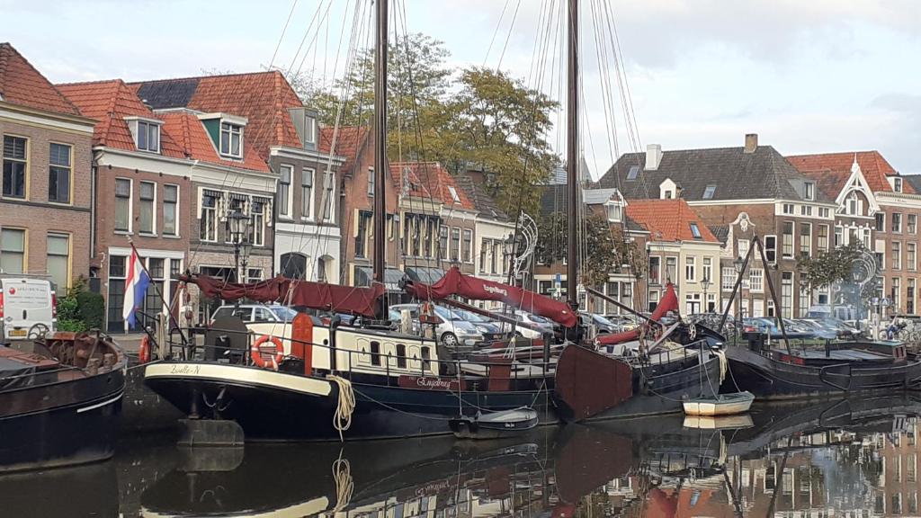 a group of boats docked in the water near buildings at Klipper Engelburg in Zwolle