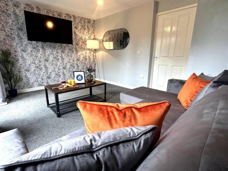 a living room with a couch and a table at Newham House by Blue Skies Stays in Stockton-on-Tees