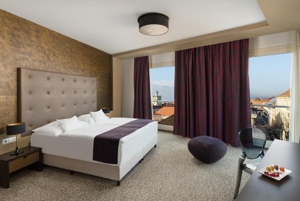Postel nebo postele na pokoji v ubytování Corso Hotel Pécs