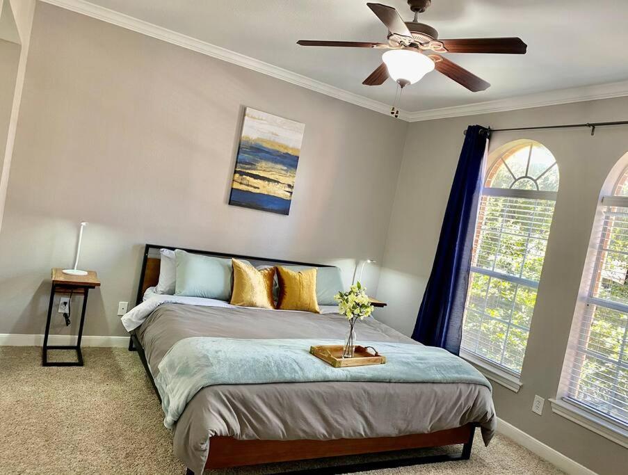 a bedroom with a bed and a ceiling fan at Peaceful Apt Home FREE PKNG Private Balcony in Houston
