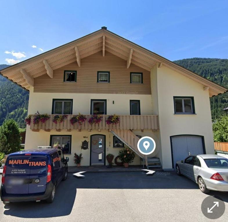 a building with a van parked in front of it at Ferienwohnung Marlin in Sankt Gallenkirch