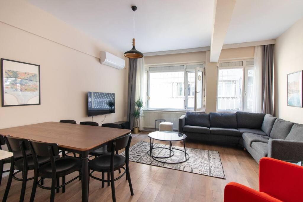 a living room with a table and a couch at Spacious & Trendy 3BR Urban Home w/ ACs in Istanbul