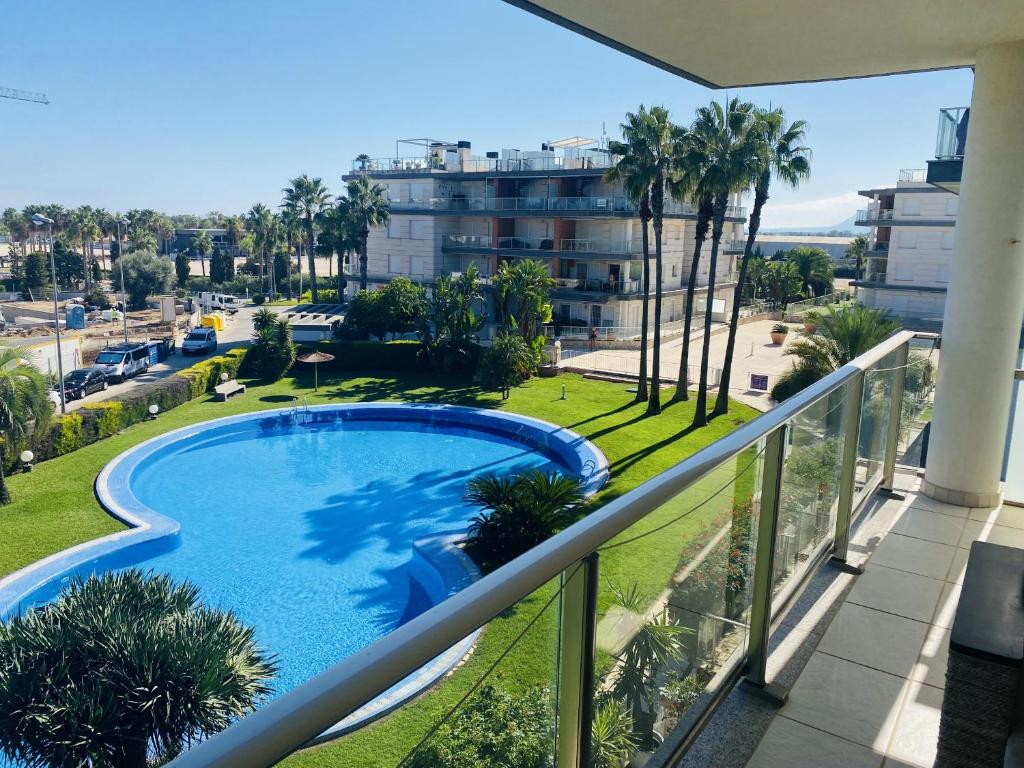 a balcony with a swimming pool and palm trees at Anacasa Albatros MET Oliva Nova Golf AP463 in Oliva
