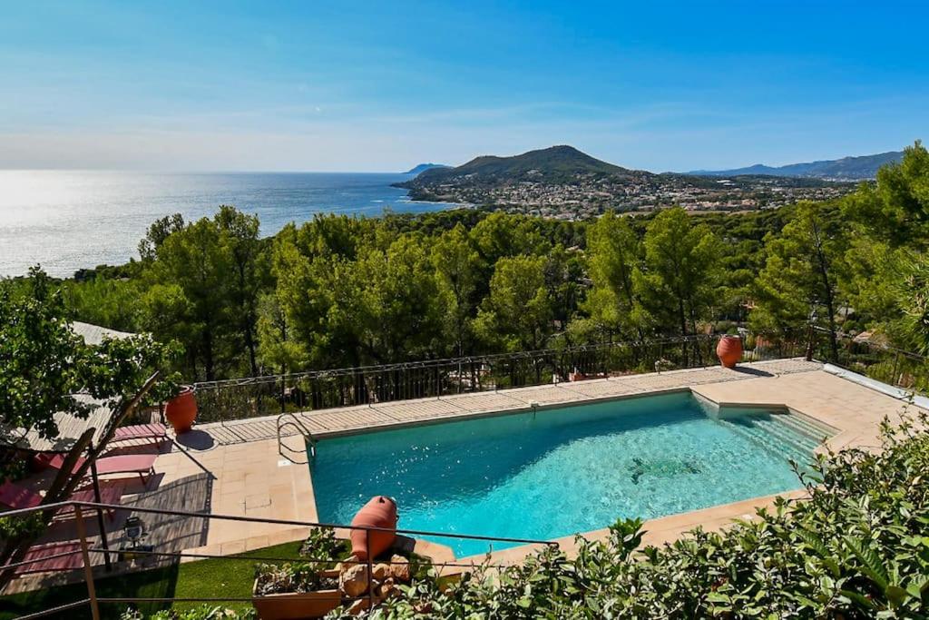 a swimming pool with a view of the ocean at Villa Terracotta - Stunning Sea View & Pool in Carqueiranne