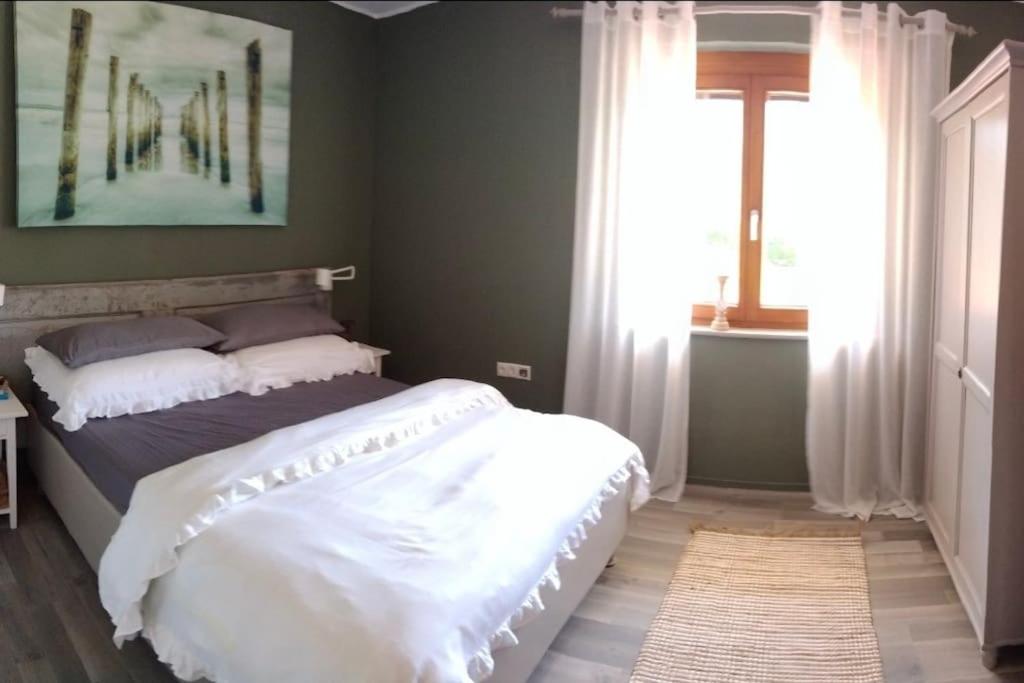 a bedroom with a bed and a painting on the wall at Liebevoll eingerichtete Wohnung in Rankweil