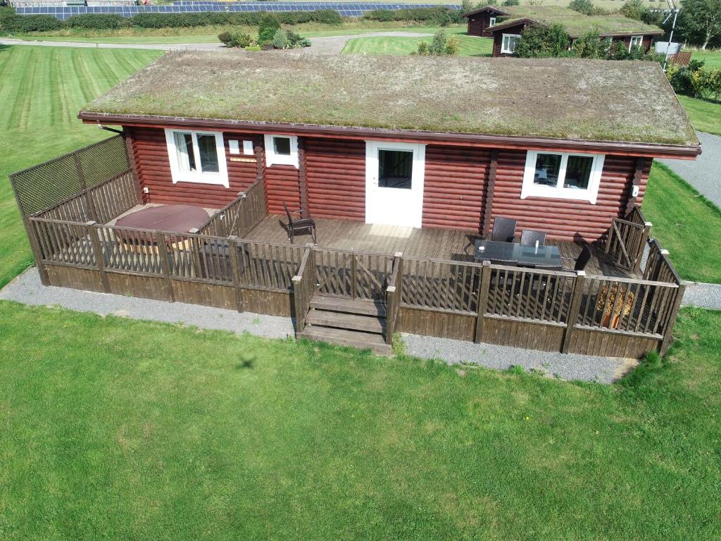 an aerial view of a house with a large deck at Teal Lodge - Nordic Log Cabin with private hot tub in Selby