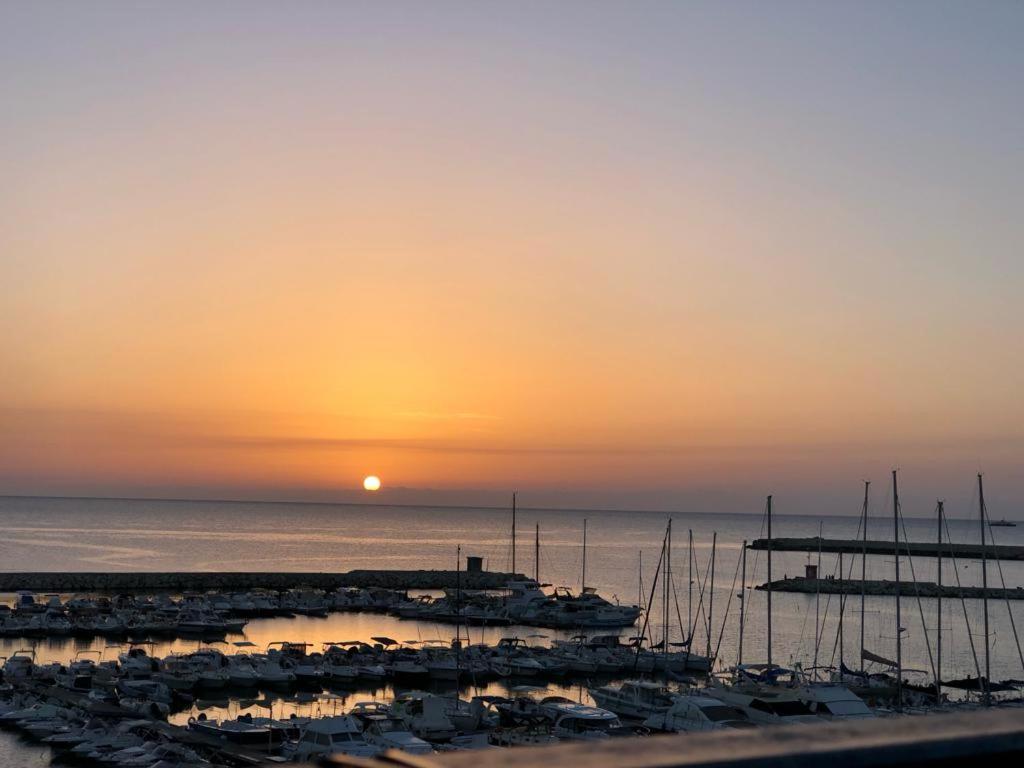 a group of boats parked in a marina at sunset at Ortigia D'aMare Apartment in Siracusa