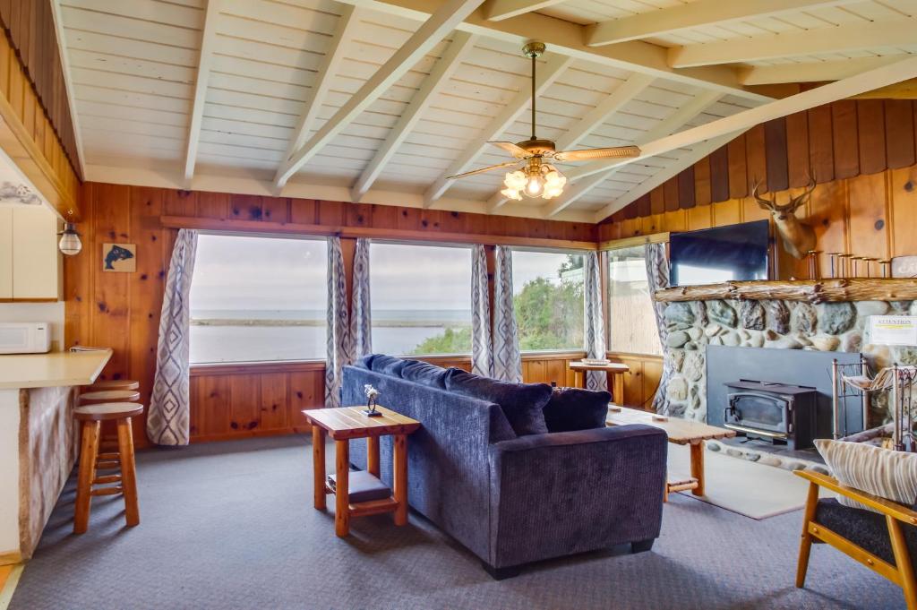 een woonkamer met een bank en een open haard bij Rustic Coastal Smith River Cottage with Ocean Views! in Smith River