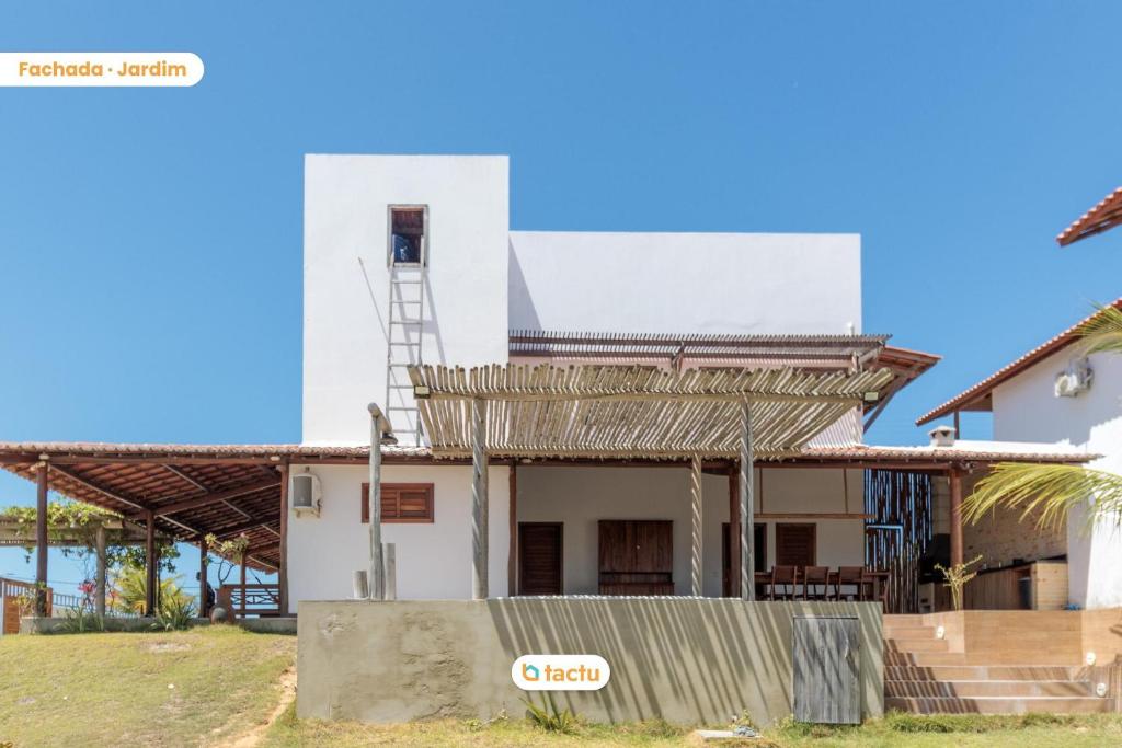 a house with a tower on top of it at Casa a 150m da praia no Pontal do Maceió por Tactu in Maceio